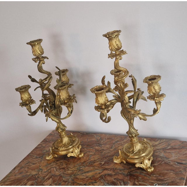 A superb pair of finely chased and gilded bronze candelabra in the Louis XV Rococo style, dating from the 19th century. ■...