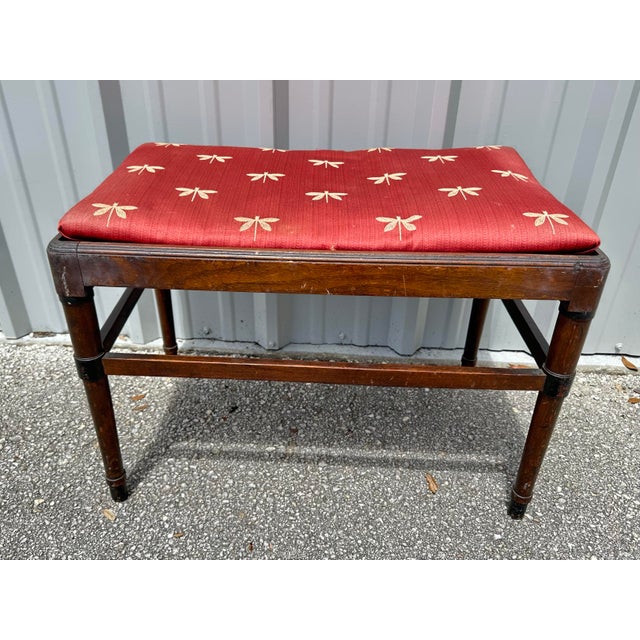 Antique wood bench with fabric seat. Fabric is red in color with gold dragonflies. Measures 25 1/2” wide x 16” deep x 19”...