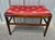 Antique wood bench with fabric seat. Fabric is red in color with gold dragonflies. Measures 25 1/2” wide x 16” deep x 19”...