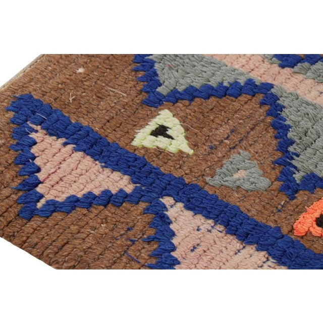 Hand-knotted in wool and originating from Morocco circa 1950-1960, this 2x8 vintage Moroccan rug is an extremely rare...
