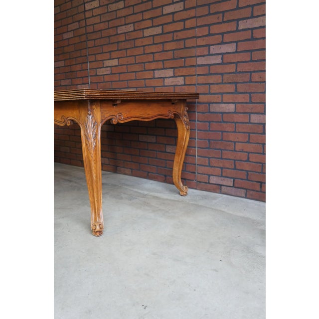 History, craftsmanship and the beauty of Oak pattern veneer top combine in this lovely antique French dining table. The...