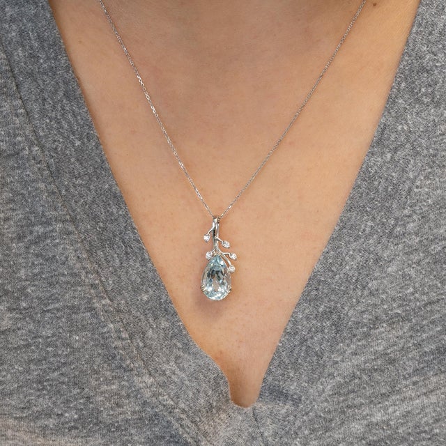 Elegant aquamarine pendant (15x10mm) set in solid 14K gold, radiating serene icy-blue brilliance. Enhanced with natural...