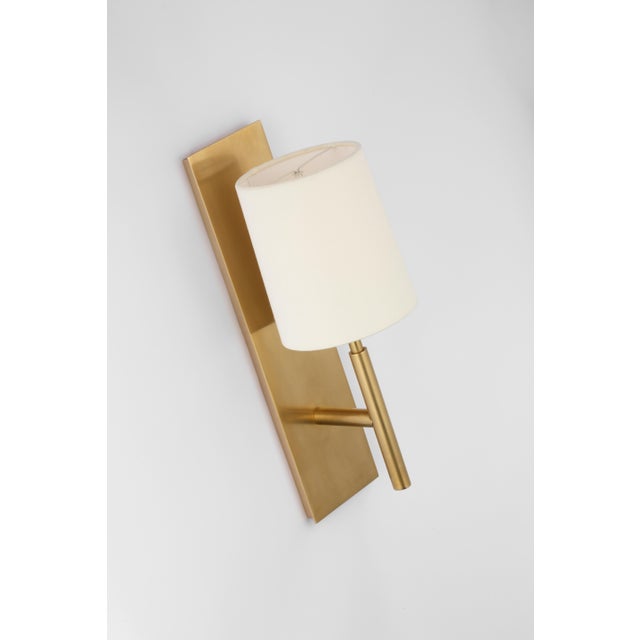 Clarion Medium Sconce in Soft Brass with Linen Shade Designer: Barbara Barry Height: 16" Extension: 6.75" Backplate: 3.75"...