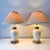 Vintage pair of Stiffel brass daisy collared cream porcelain table lamps with original pleated empire lampshades.