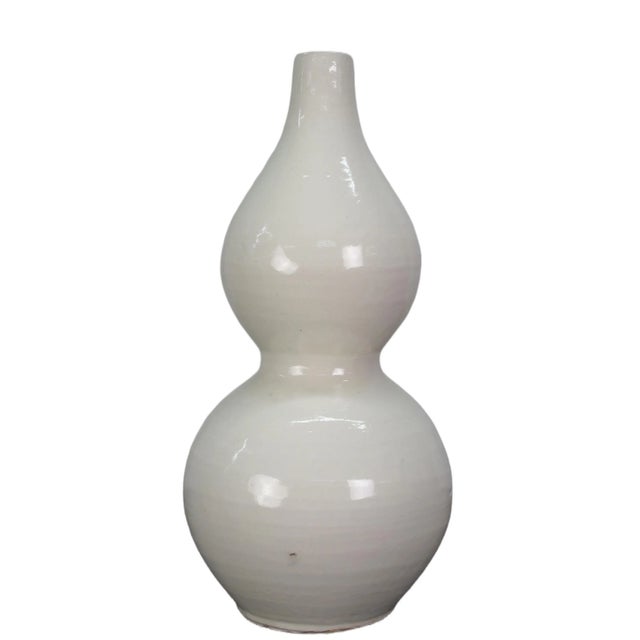 This white bottle gourd shape vase is handmade, each vase has its own unique variance. Its elegant and timeless design...