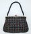 This delicate and ultra feminine C.1950 French black seed bead handbag features a floral chain stitch pattern in pastel...