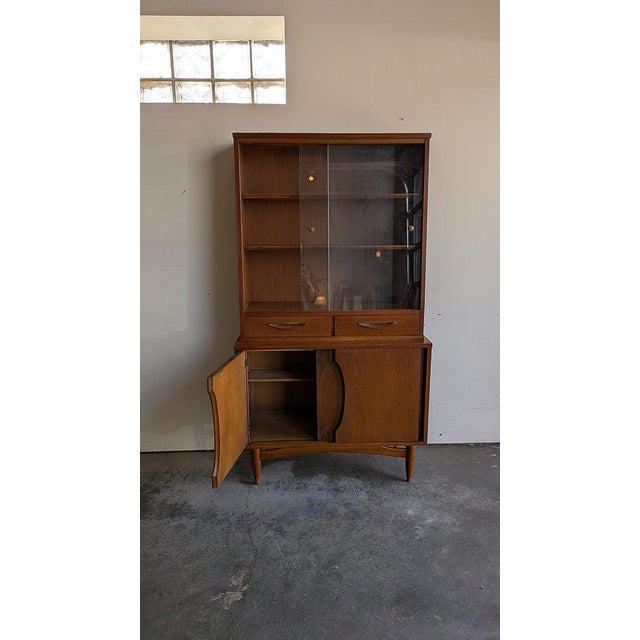DESCRIPTION A clean, architectural mid-century modern hutch by Garrison, featuring a beautifully balanced two-piece design...