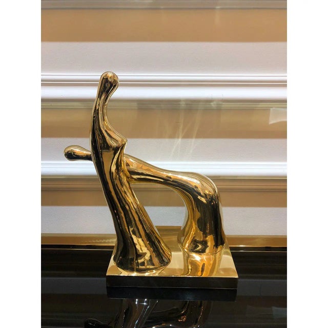 Crafted in Bronze and finished with a gold touch, this sculpture offers a striking artistic accent piece to your decor....