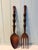 A striking pair of oversized hand-carved wooden salad servers, featuring sculptural stacked-orb handles and deep, richly...