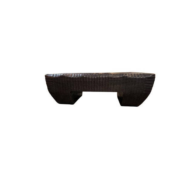 A bold expression of modern organic design, this sculptural coffee table is handcrafted from solid suar wood and showcases...
