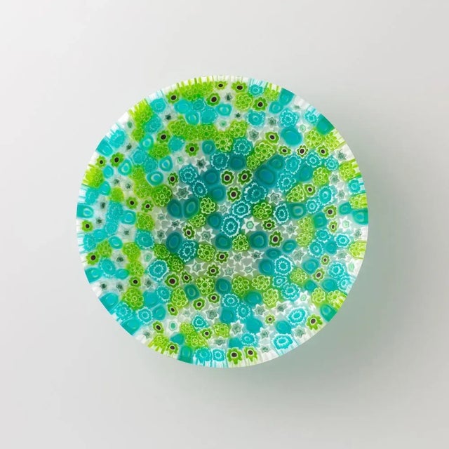 Murano glass bowl made by melting together sections of glass rods in a furnace, with each section depicting a small...