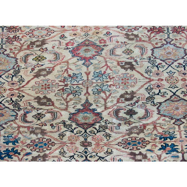 A fabulous early 20th century Persian Sultanabad rug with an overall repeated and mirrored floral and scrolling vine...