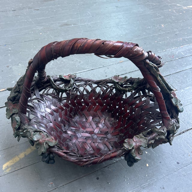 Antique Japanese woven bamboo ikebana basket. Some breakage on the handle and small stains throughout. Some cracks on...