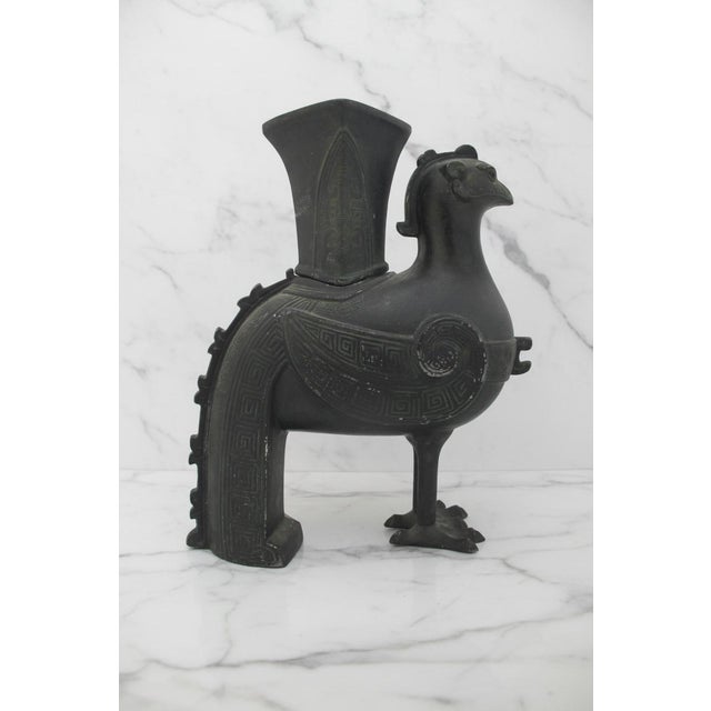 Patinated bronze Chinese Zun vessel in form of a Phoenix or heavenly rooster bird, inspired by ancient Shang and Zho...