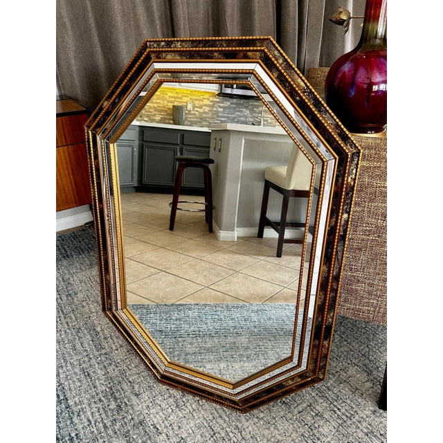 Venetian style 8 sided gilt wood wall mirror, accented with smaller clear and gold vein mirror panels. A wonderfully...