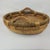 Handcrafted round wicker basket features a sturdy woven design with integrated wooden handles, perfect for rustic home...