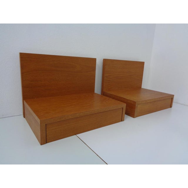 Pair of teak consoles with drawers.