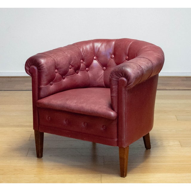 A characterful and elegant Swedish Chesterfield armchair dating from the 1930s, executed in rich red-brown leather. This...