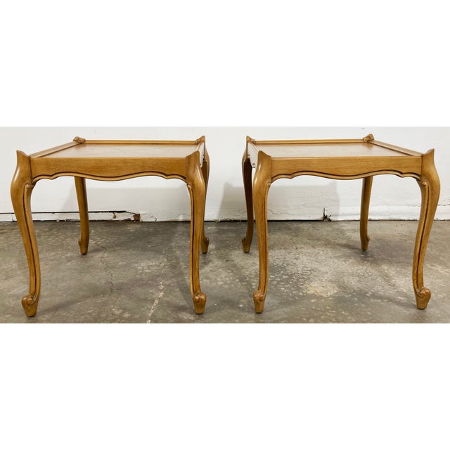 Pair of classic wood French Provincial style tables featuring curved legs and frame with X cross detail to tabletops....