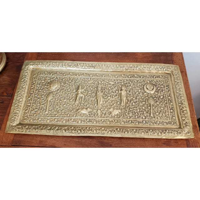 This captivating 19th-century Indian brass plaque, crafted circa 1850, is richly adorned with intricate hand-embossed...
