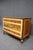 An elegant three-drawer dresser by Robert Irwin, crafted in satinwood veneers with finely painted neoclassical decoration...