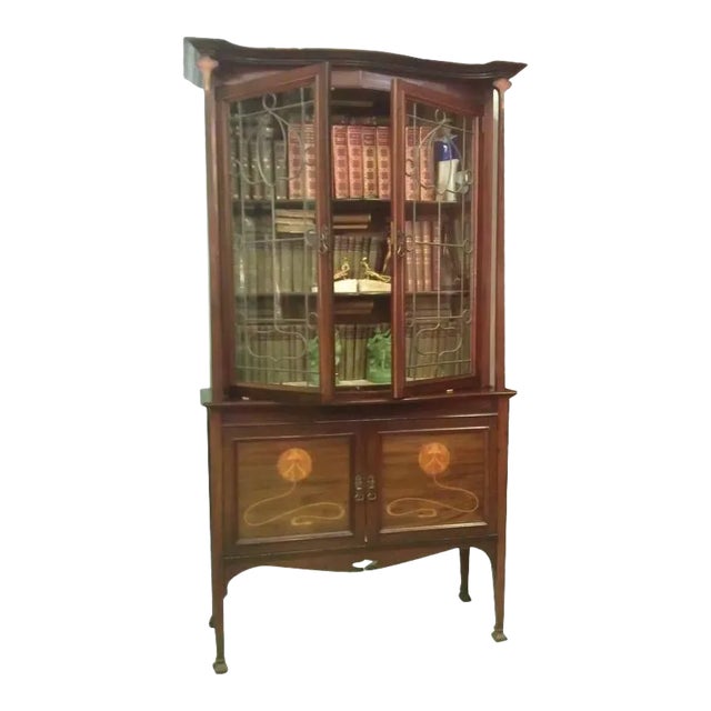 A beautiful iconic Majorelle style Art Nouveau mahogany cabinet with gracefully tapered columns terminating in stylized...