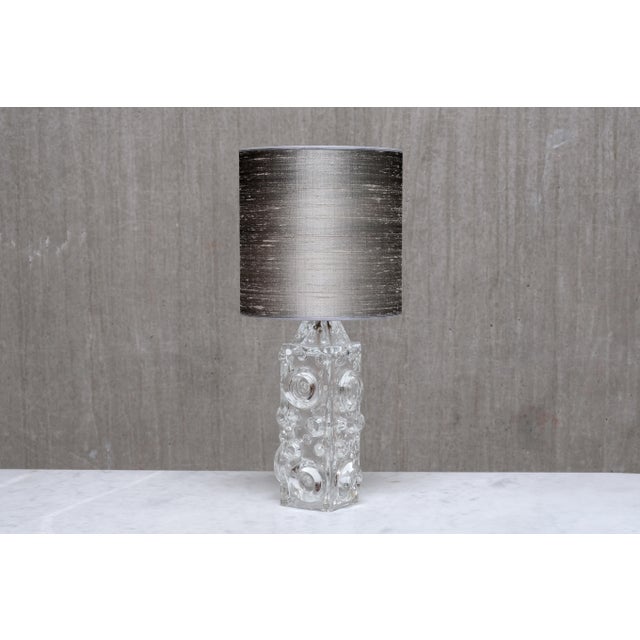This table lamp was designed by Josef Schott in the 1960s and produced by Smålandshyttans Glasbruk in Sweden. The design...