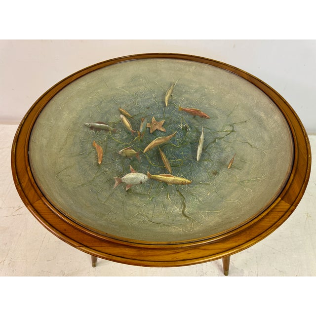 This table is a remarkable example of mid-century furniture design, characterized by its elegant wooden frame and the...