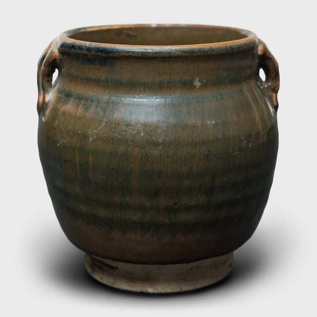 This small glazed jar from China's Shanxi province exemplifies the timeless appeal of handcrafted pottery. Once used in an...