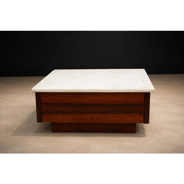 Attributed to an unknown Brazilian workshop and produced in the mid-20th century, this square coffee table reflects the...