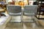 A pair of modern style cantilever chromed steel frame armchairs with gray tufted upholstery. Unmarked.