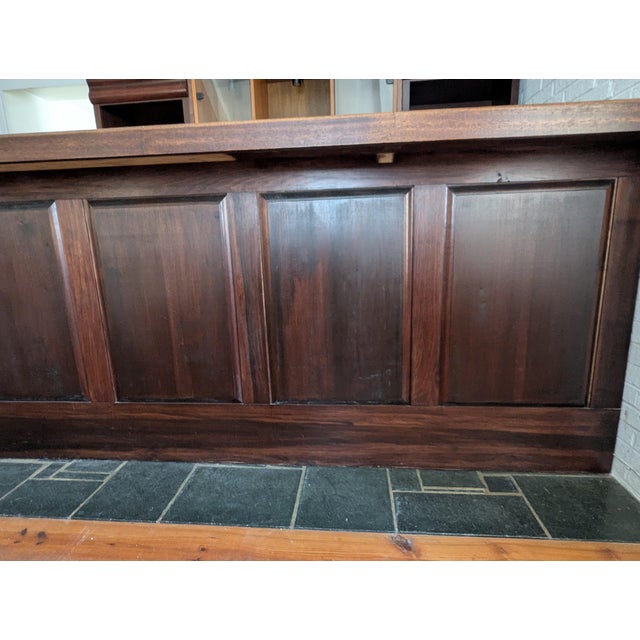 Bar has black slate-like top with wood - oak, pine, and veneer. Behind cabinet shelving with and without doors. Ample room...