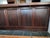 Bar has black slate-like top with wood - oak, pine, and veneer. Behind cabinet shelving with and without doors. Ample room...