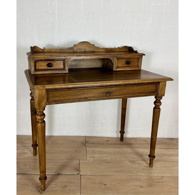 Elegant writing desk crafted in oak, featuring a refined raised gallery with two small drawers, an open central...