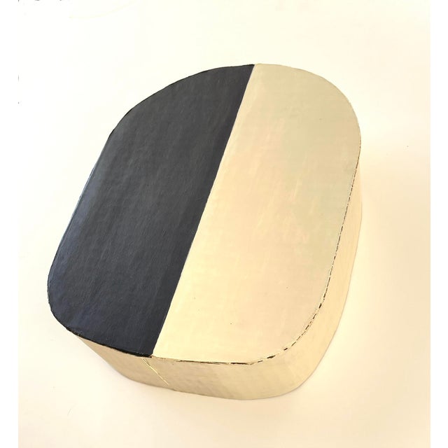 This 3-D piece is a minimalist study of contrast made with cardboard and black and cream paint. Perfect for a wall or...