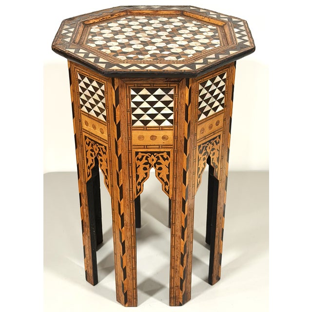 This is a small Middle Eastern side table with a six-sided top, probably made in Morocco. It has mother of pearl inlay and...