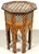 This is a small Middle Eastern side table with a six-sided top, probably made in Morocco. It has mother of pearl inlay and...