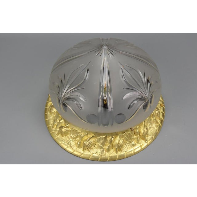 - French Art Nouveau period bronze and cut frosted glass flush mount, from circa 1920. - This adorable ceiling light...