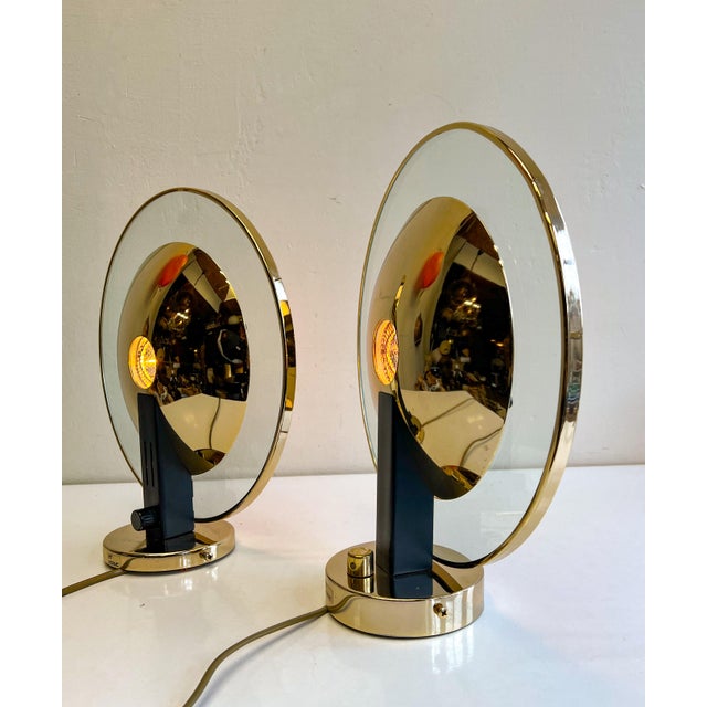 A pair of chic round sconces Estiluz Spain. They are made of a beautiful and heavy quality glass and brass and have a...