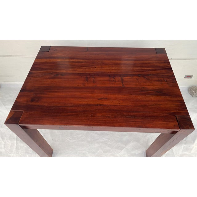 A unique, massive table made of solid exotic wood, rosewood. This piece boasts beautiful grain, a refined color, and a...