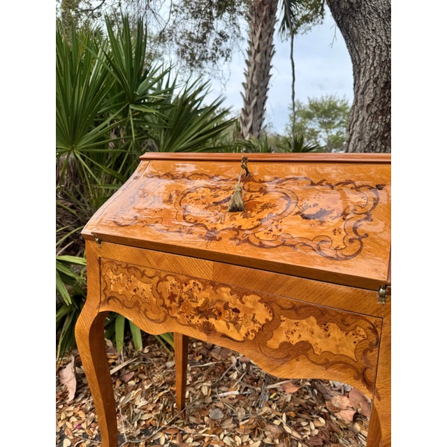 Elegant Louis XV–style bureau de dame (ladies’ writing desk) featuring exquisite marquetry inlay and graceful cabriole...