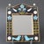 Ceramic wall mirror with birds and flowers (circa 1970s) by Mithé Espelt. A delightful decorative piece topped with two...