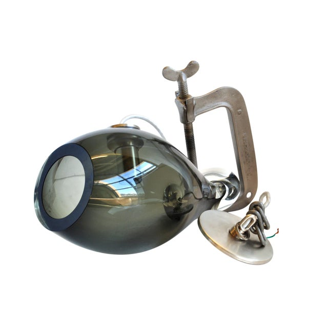 An industrial pendant with a "C" clamp and blown glass. A wonderful piece for your home. Note, the canopy was been removed...