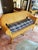 Honey-toned wicker loveseat bench with a classic curved barrel back and open armrests. Tightly woven throughout, kept...