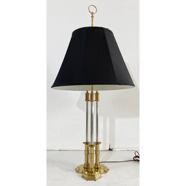 Grand vintage Mid Century Hollywood Regency style table lamp made by Chapman featuring solid brass base and caps with...