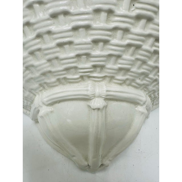 This is a ceramic wall pocket planter designed to hang on a wall. Appearance • Semi-circular shape with a flat back and...