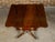 An English Regency period mahogany Pembroke table from the 19th century with drop leaves, cross-banding, single drawer and...
