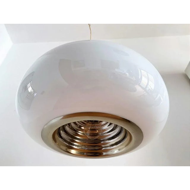 Beautiful pendant lamp called "black and white 83" of the Italian mid-century with opal white glass bowl and aluminum...