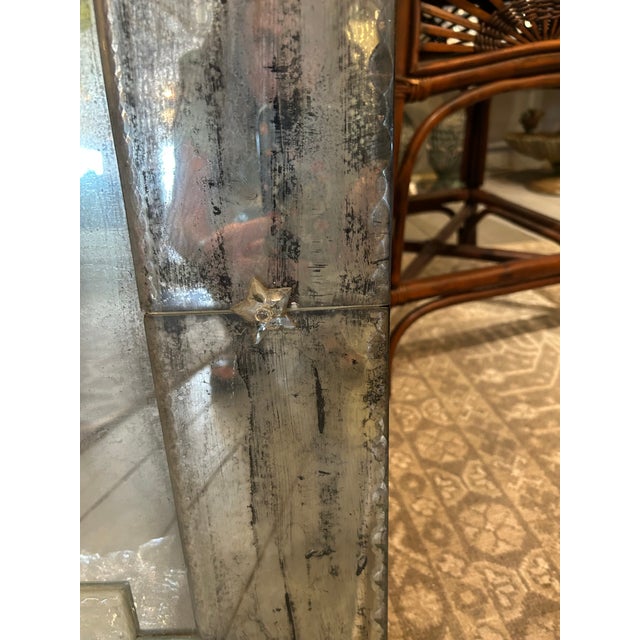 Large dramatic skyscraper mirror having ghosted aged mirror.