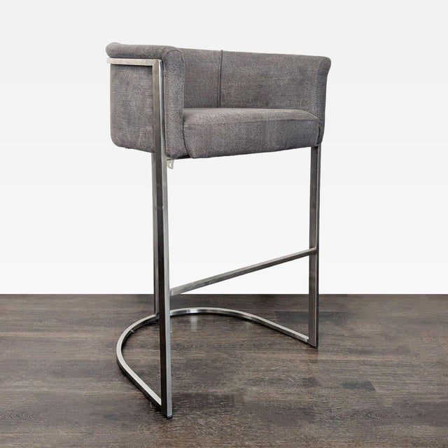 This Euro Style counter stool features a soft grey upholstered seat and back for comfort. Its sturdy metal frame adds a...